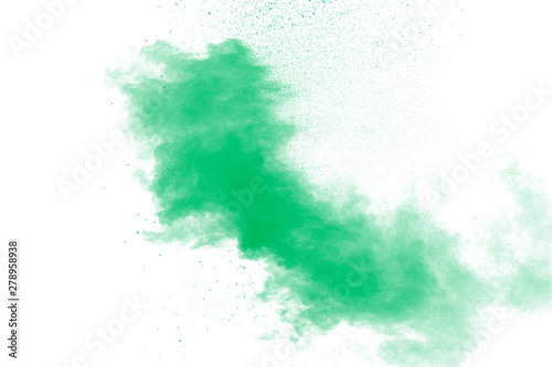 Freeze motion of green dust explosion on white background. Throwing green powder out of hand against background.