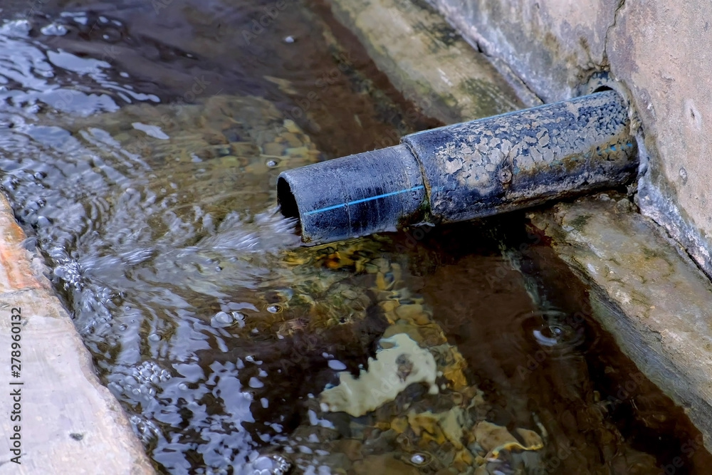 Water is poured out of the pipe. Storm drain pipe can not cope with the