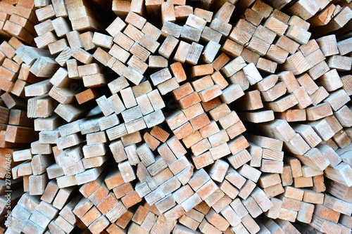 A large stack of wood boards in a lumber yard photo