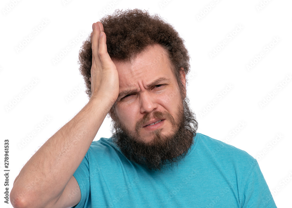 Crazy bearded Man with funny Curly Hair, suffering from headache. Upset unhappy Sick guy squeezing head with hands, writhing in pain. People, healthcare, stress or migraine concept Crazy bearded Man with funny Curly Hair, suffering from headache. Upset unhappy Sick guy squeezing head with hands, writhing in pain. People, healthcare, stress or migraine concept