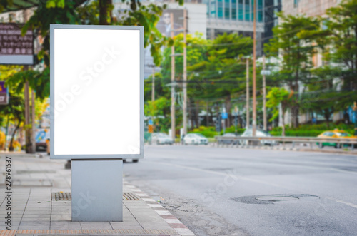 blank billboard advertising banner at outdoor in city side road. vertical digital LED poster mock up display board ad sign on path way on street.