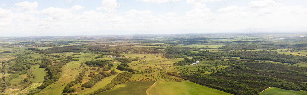 Fototapeta premium panoramic shot of beautiful landscape with green hills under blue sky with clouds in rome, italy