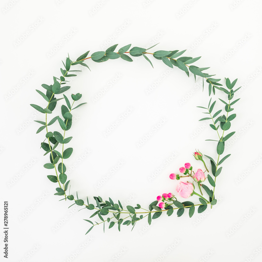 Floral wreath frame made of pink roses and eucalyptus branches on white background. Flat lay, top view Floral wreath frame made of pink roses and eucalyptus branches on white background. Flat lay, top view