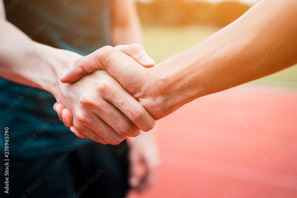 Concept Of Negotiating Business Or Competition And Handshake Gesturing People Connection Deal Close Up Hand Of Young Man Shaking Hands With Rival Or Partner Or Customer On Modern Outdoor Fair Play Stock Photo