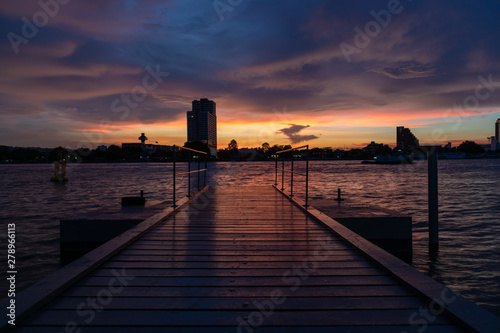 Boat Dock on river with Beautiful Sunset Twilight Time Background. Landscape Concept.