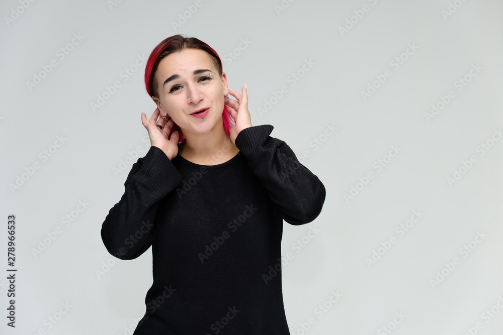Portrait to the waist of a pretty girl with red hair on a white background in a black jacket. Standing right in front of the camera in a studio with emotions, talking, showing hands, smiling Portrait to the waist of a pretty girl with red hair on a white background in a black jacket. Standing right in front of the camera in a studio with emotions, talking, showing hands, smiling