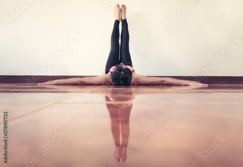 Blurred background of Yoga Woman feet up on wall relaxing, unrecognised person.