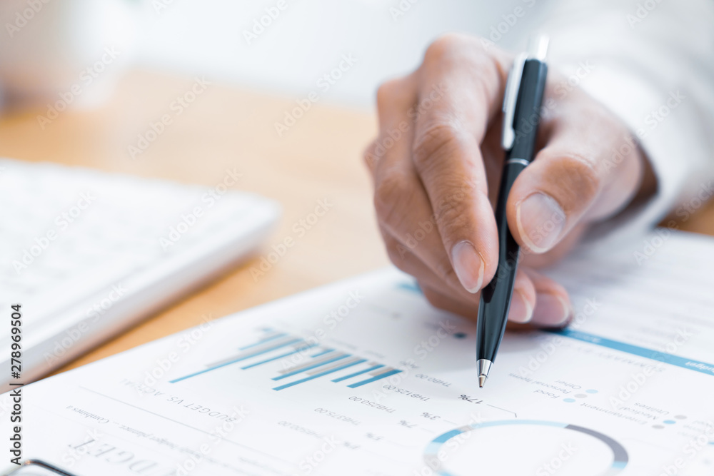 Close-up of hands Businessman reading and writing with pen signing contract over document for Completing Application Form at work in office. Close-up of hands Businessman reading and writing with pen signing contract over document for Completing Application Form at work in office.