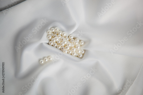 Ivory beads on white wedding fabric