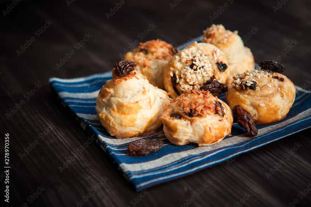 puff buns with raisins on a blue background puff buns with raisins on a blue background