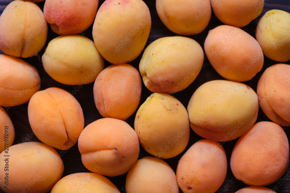 freshly picked orange apricots on a wooden background freshly picked orange apricots on a wooden background