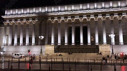 Left to right slow timelapse of the Cour d'assise, Courts of Appeal, Lyon, floodnight by night with the busy city life photo