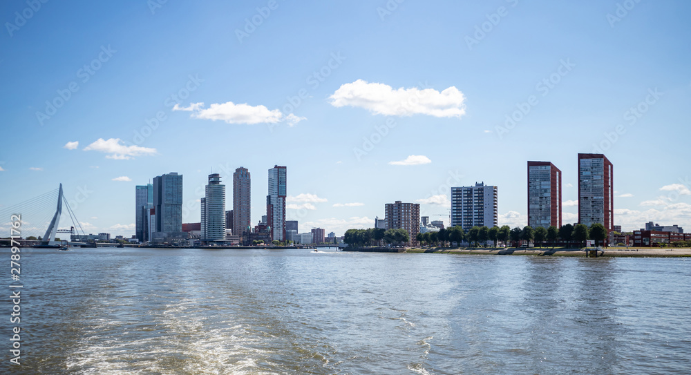 Cityscape and Erasmus bridge, sunny day. Rotterdam, Netherlands.