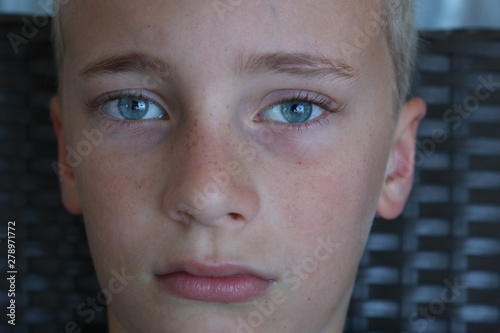 Portrait of an adolescent boy with a serious stare
