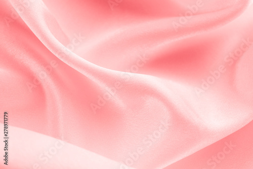 folds of coral fabric background, space for text