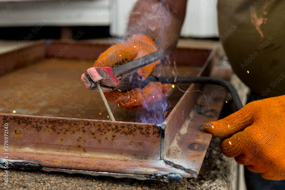 Fastening parts of metal under high temperature using a short circuit. Welding work on the metal. Fastening parts of metal under high temperature using a short circuit. Welding work on the metal.