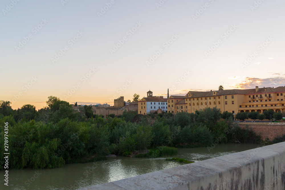 Evening view over the Roman bridge to the old town of Cordoba