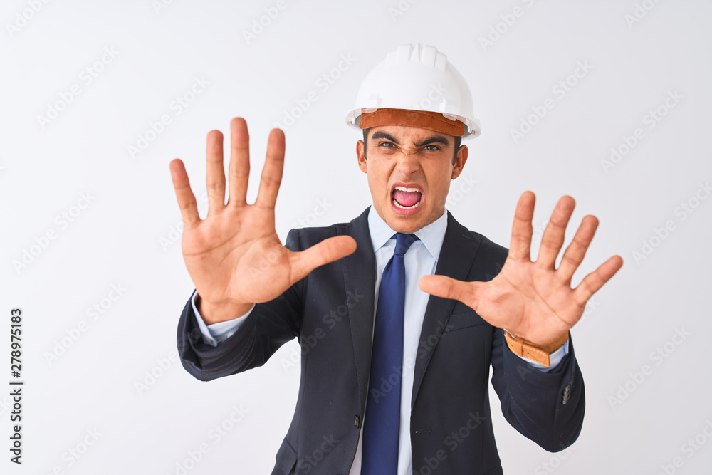 Young handsome architect man wearing suit and helmet over isolated white background afraid and terrified with fear expression stop gesture with hands, shouting in shock. Panic concept. Young handsome architect man wearing suit and helmet over isolated white background afraid and terrified with fear expression stop gesture with hands, shouting in shock. Panic concept.