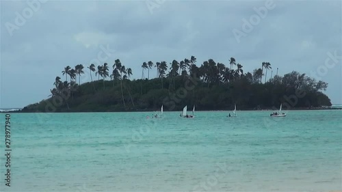 Boats & Catamaran Or Hobie Cat Yachts Sailing On Muri Lagoon Reef In Water Near Tropical Islands & Sandy Beach In Wind On Windy Day In Rarotonga Cook Islands South Pacific Polynesia photo