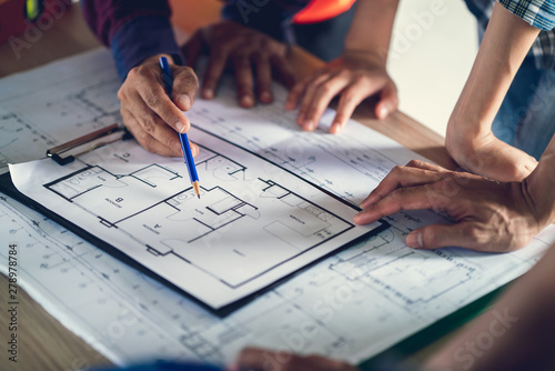 Architect & Engineer working drawing document about project planning and progress of work schedule on the home building construction site , Drawing docement is make new for stock NOT COPYRIGHT