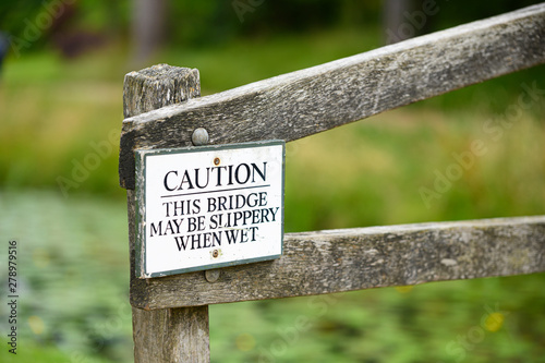 Caution this bridge may be slippery when wet sign