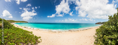 Panorama picture of white sandy beach and turquoise waters on carrebian island of St. Maarten