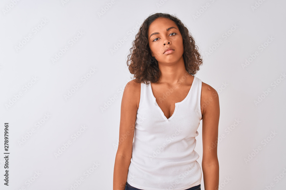 Young brazilian woman wearing casual t-shirt standing over isolated white background looking sleepy and tired, exhausted for fatigue and hangover, lazy eyes in the morning. Young brazilian woman wearing casual t-shirt standing over isolated white background looking sleepy and tired, exhausted for fatigue and hangover, lazy eyes in the morning.