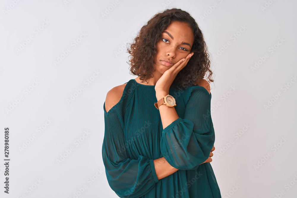 Young brazilian woman wearing green t-shirt standing over isolated white background thinking looking tired and bored with depression problems with crossed arms. Young brazilian woman wearing green t-shirt standing over isolated white background thinking looking tired and bored with depression problems with crossed arms.