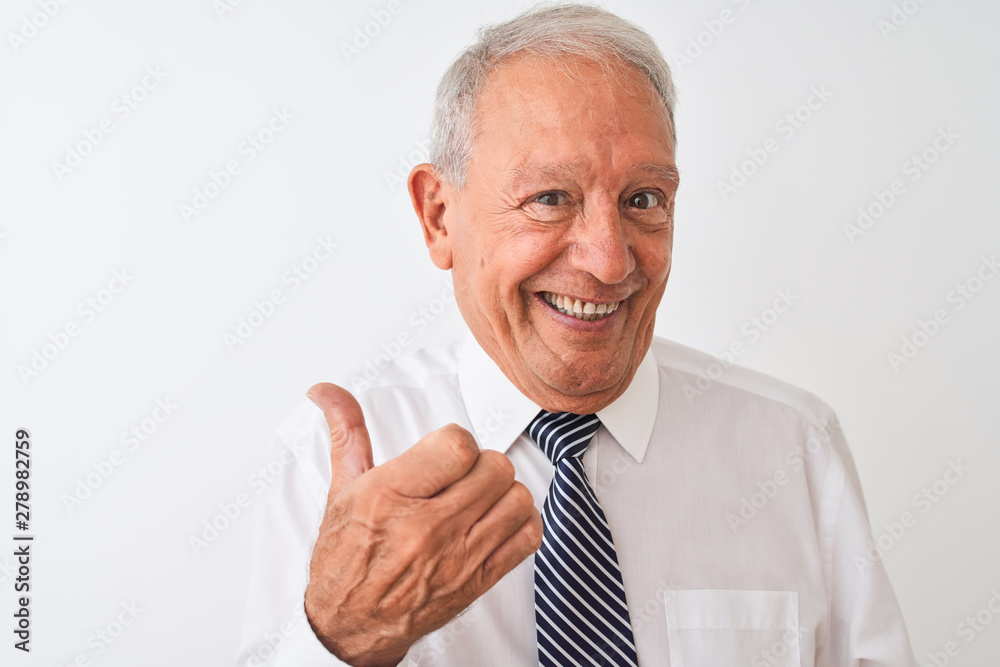 Senior grey-haired businessman wearing tie standing over isolated white background pointing and showing with thumb up to the side with happy face smiling Senior grey-haired businessman wearing tie standing over isolated white background pointing and showing with thumb up to the side with happy face smiling