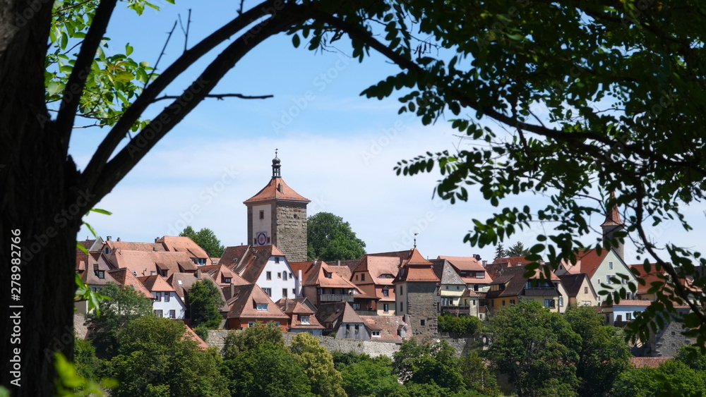 View of Rothenburg ob der Tauber framed by tree View of Rothenburg ob der Tauber framed by tree