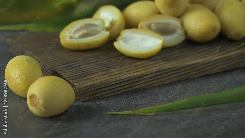 The date-palm fresh they are placed on the table with oil, health food concept., Date Palm. Raw Date Palm(Phoenix dactylifera) fruits The date-palm fresh they are placed on the table with oil, health food concept., Date Palm. Raw Date Palm(Phoenix dactylifera) fruits