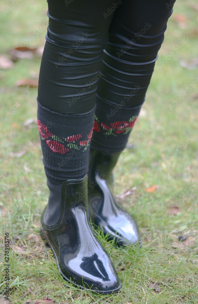 Autumn Boots. Woman with waterproof shiny black boots. Selective focus. Autumn Boots. Woman with waterproof shiny black boots. Selective focus.