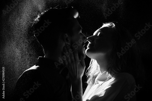 black and white silhouette of a kissing couple