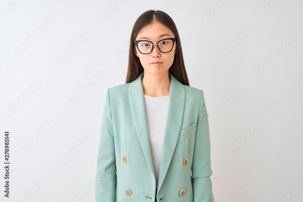 Chinese businesswoman wearing elegant jacket and glasses over isolated white background Relaxed with serious expression on face. Simple and natural looking at the camera. Chinese businesswoman wearing elegant jacket and glasses over isolated white background Relaxed with serious expression on face. Simple and natural looking at the camera.
