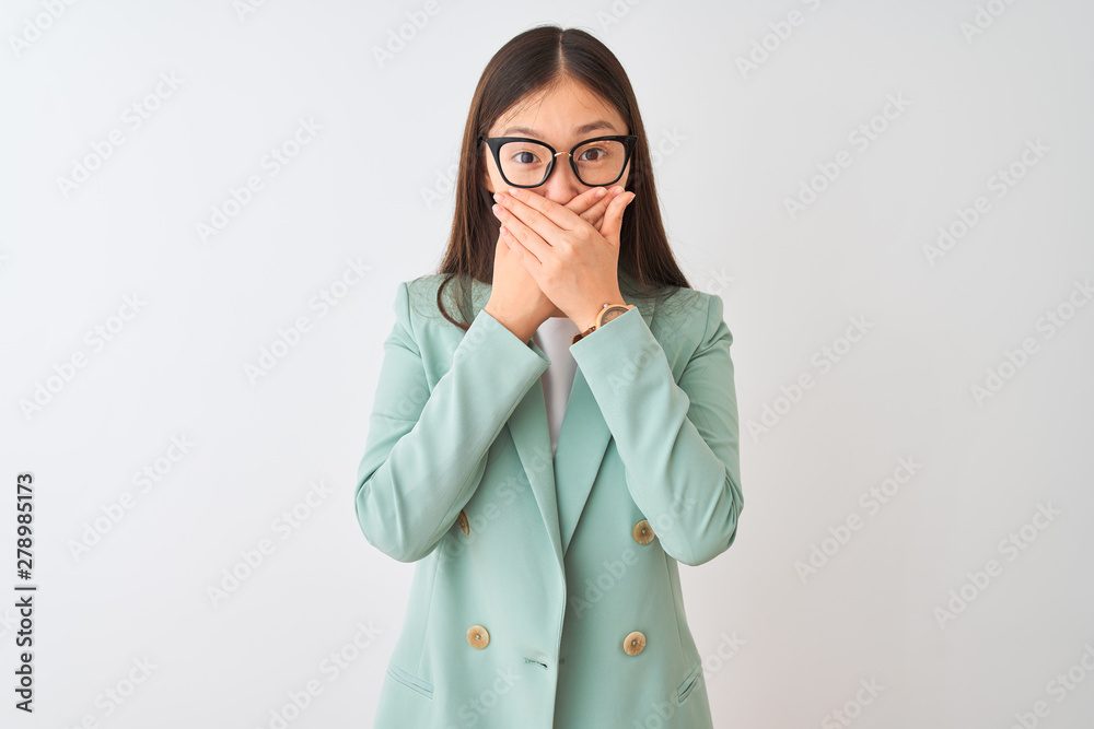 Chinese businesswoman wearing elegant jacket and glasses over isolated white background shocked covering mouth with hands for mistake. Secret concept. Chinese businesswoman wearing elegant jacket and glasses over isolated white background shocked covering mouth with hands for mistake. Secret concept.