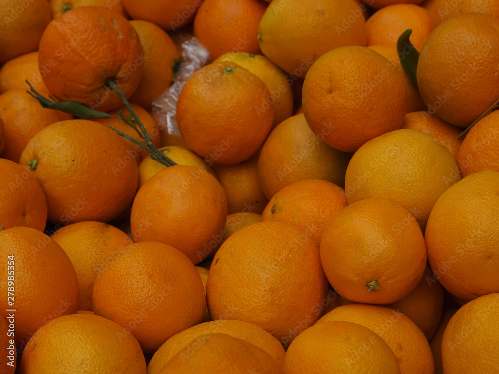 Ripe juicy bright red sweet orange. Summer is a time of a healthy lifestyle and tasty fruits and vegetables. Yellow canary type. Closeup image of tasty harvest in sale on the market at the street. Ripe juicy bright red sweet orange. Summer is a time of a healthy lifestyle and tasty fruits and vegetables. Yellow canary type. Closeup image of tasty harvest in sale on the market at the street.