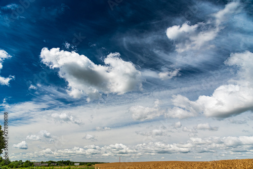 Beautiful clouds over a field of wheat. © shymar27