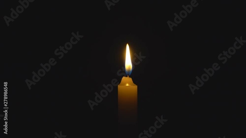 A single white candle burning. Looping for use as a background or illustration of remembrance or celebration. The wind tries to put out the flame, but it recovers each time. The eternal flame.