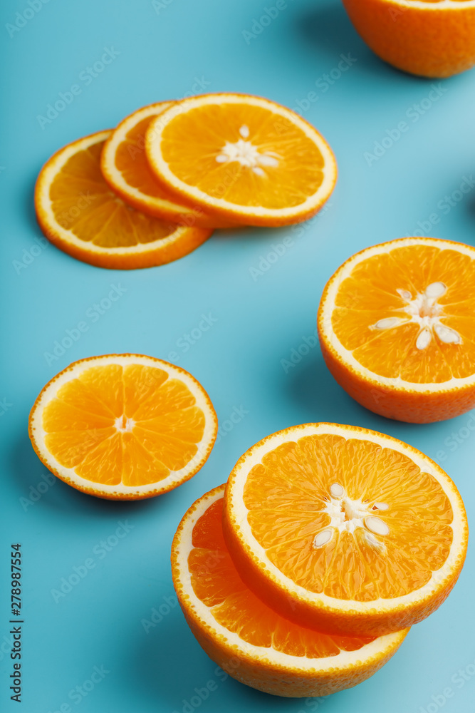 Slices and slices of orange pulp on a bright blue background as a textural background, the substrate. Full screen Flat lay, top view. Food background Slices and slices of orange pulp on a bright blue background as a textural background, the substrate. Full screen Flat lay, top view. Food background