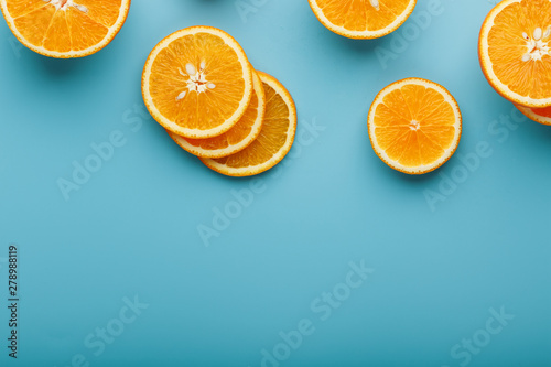 Slices and slices of orange pulp on a bright blue background as a textural background  the substrate. Full screen Flat lay  top view. Food background