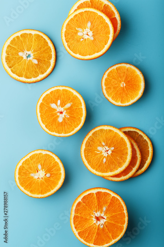 Slices and slices of orange pulp on a bright blue background as a textural background  the substrate. Full screen Flat lay  top view. Food background