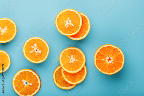 Slices and slices of orange pulp on a bright blue background as a textural background  the substrate. Full screen Flat lay  top view. Food background