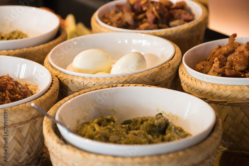 Hors-d'oeuvre ,Thai food Northern style: spicy minced pork salad, thai sausages, deep fried pork skin, spicy chilly paste, sticky rice and boiled egg.