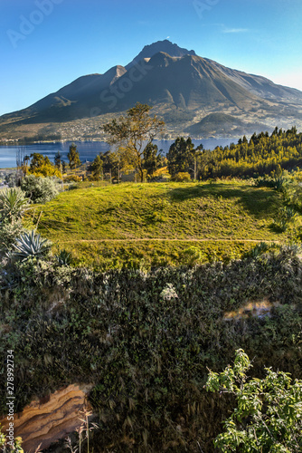 Beautiful view of the Imbabura volcano, the San Pablo lake and green fields, on a beautiful day. Ecuador, South America