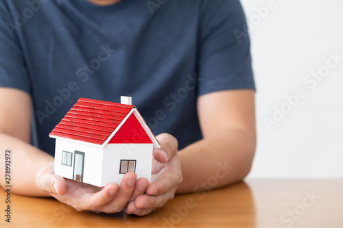 Man hands holding model of dream house