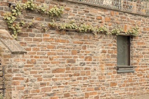 Fototapeta Naklejka Na Ścianę i Meble -  Isolated wooden window in a brick wall background (Germany, Europe)