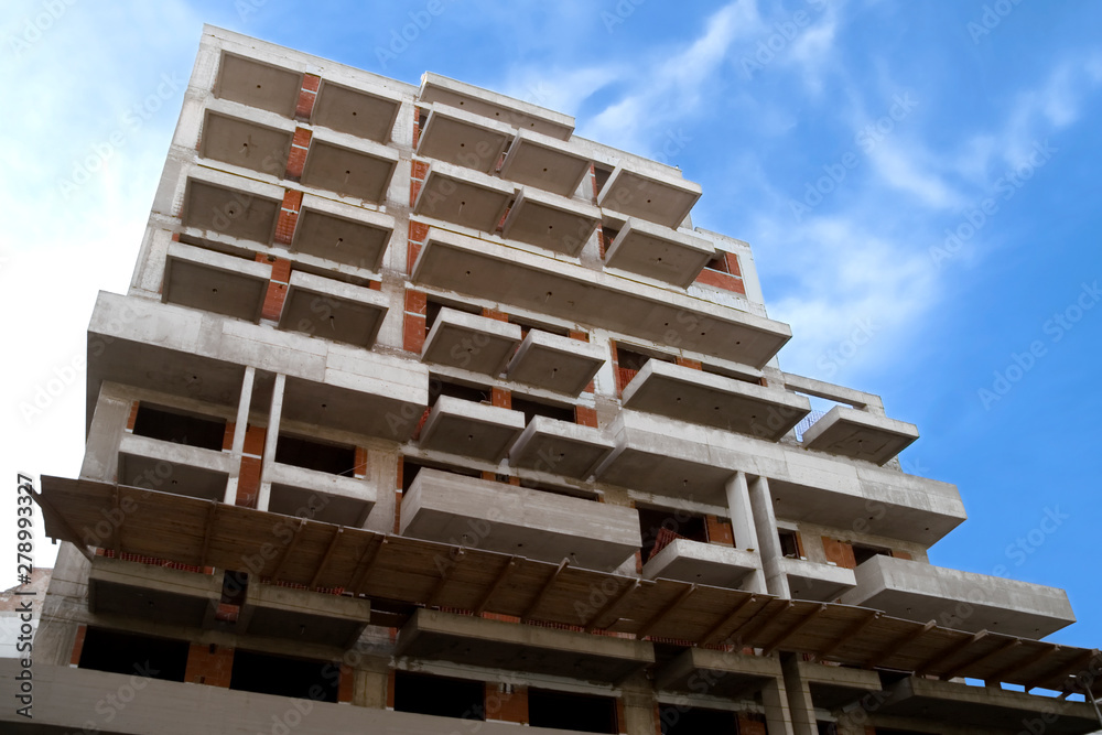 Building under construction against blue sky Building under construction against blue sky