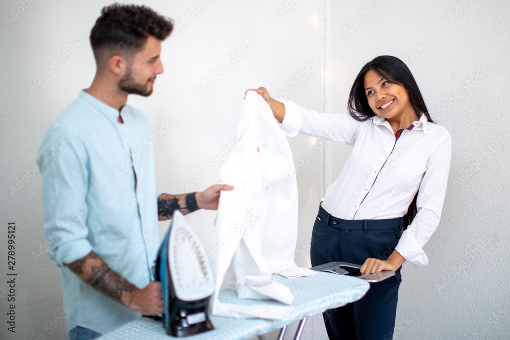 young couple asian European speaking about ironing young couple asian European speaking about ironing