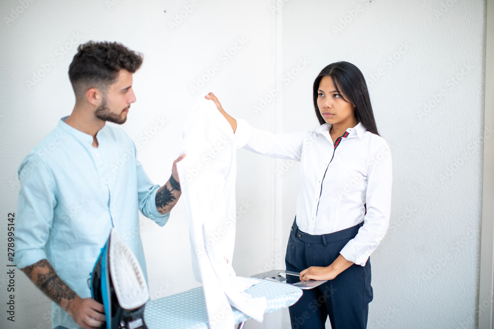 Obraz premium young couple asian European speaking about ironing