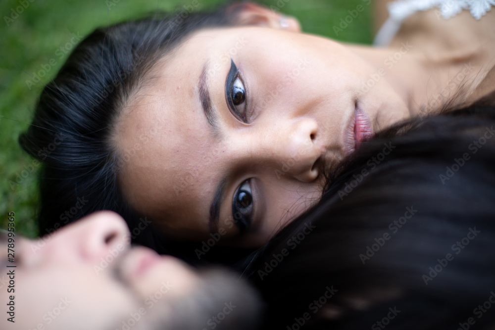young mix couple asian and European in the park in love young mix couple asian and European in the park in love